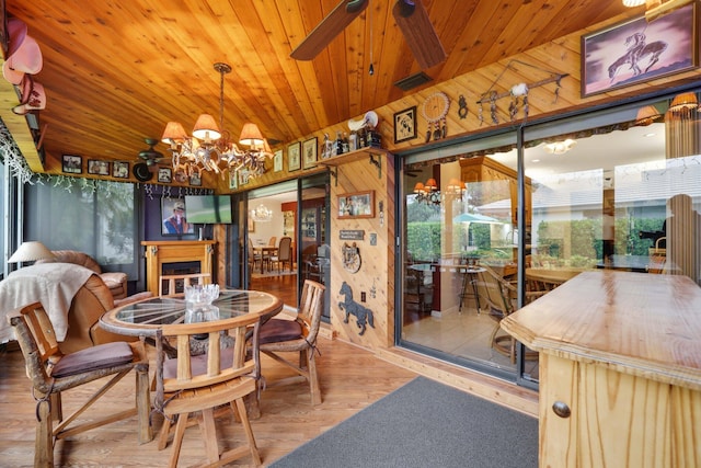 dining space featuring wooden ceiling, hardwood / wood-style flooring, plenty of natural light, and a notable chandelier