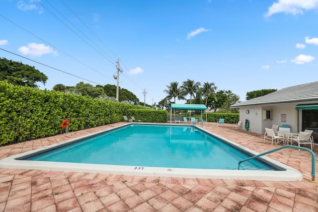 view of swimming pool featuring a patio area