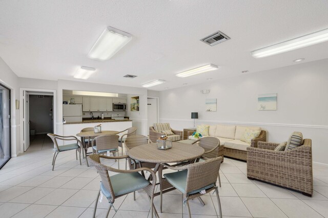 tiled dining area featuring sink