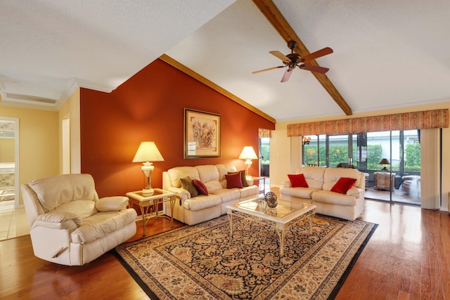 living room featuring hardwood / wood-style floors, ceiling fan, and lofted ceiling with beams