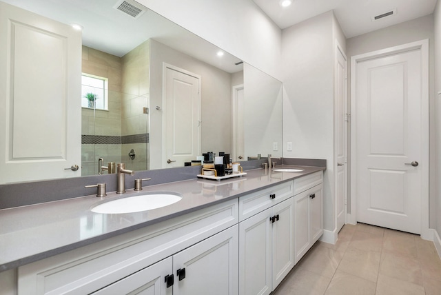 bathroom with vanity, an enclosed shower, and tile patterned floors