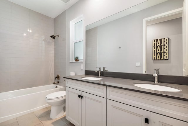 full bathroom featuring vanity, tiled shower / bath, tile patterned floors, and toilet