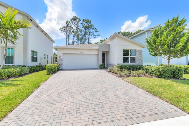 view of front of property with a garage and a front lawn