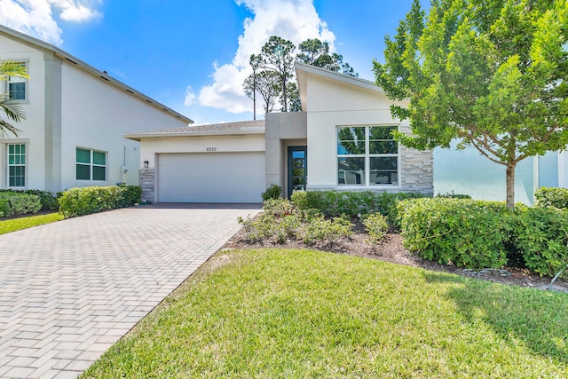 view of front of property with a front yard and a garage