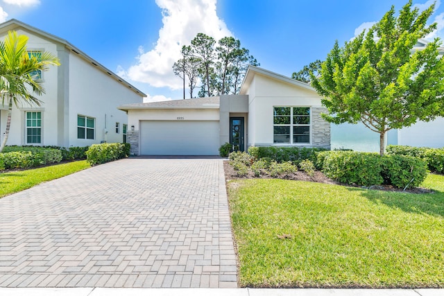 view of front of home featuring a garage and a front lawn