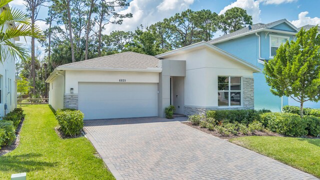 view of front of house with a front lawn and a garage