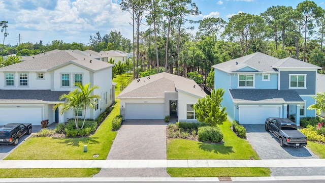 view of front of house with a front yard and a garage