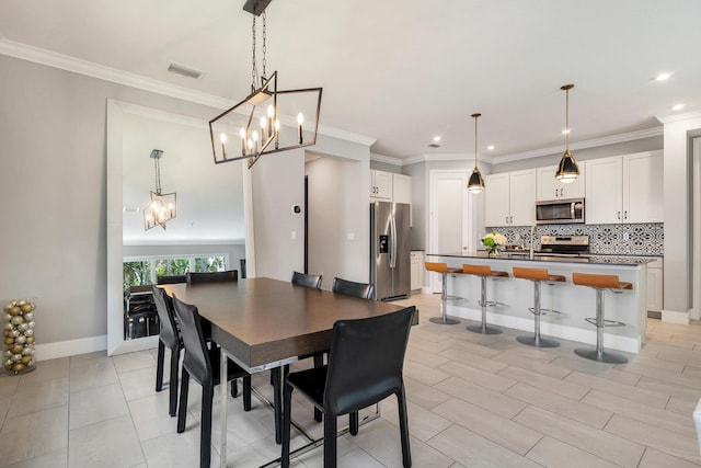 dining area featuring crown molding and a chandelier