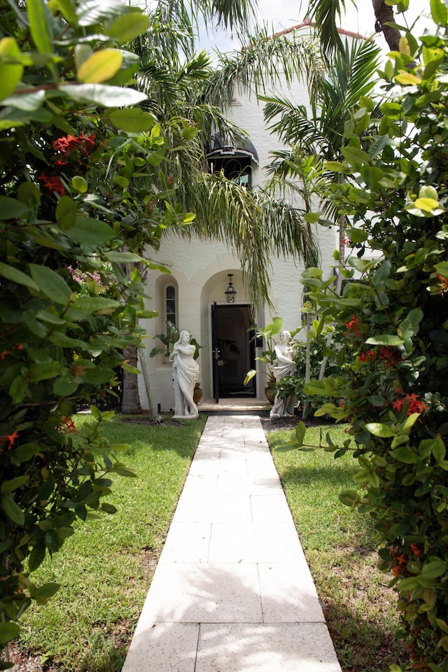 entrance to property featuring a lawn