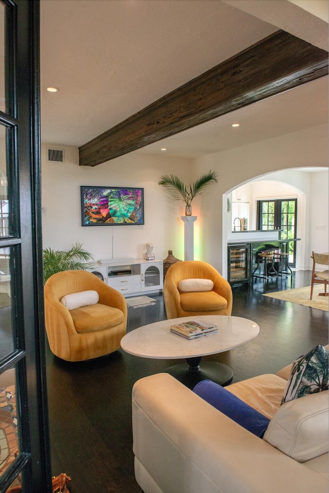 living room with wine cooler, beam ceiling, visible vents, and recessed lighting