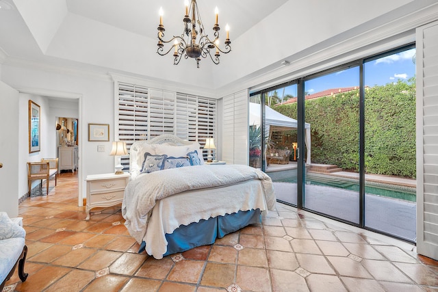 bedroom featuring a tray ceiling, an inviting chandelier, tile patterned floors, and access to exterior