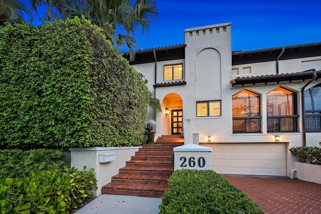 mediterranean / spanish-style house featuring a balcony and a garage