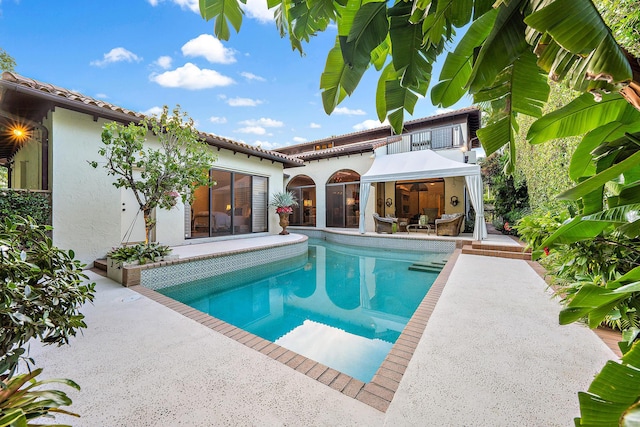 view of swimming pool with a sunroom and a patio area