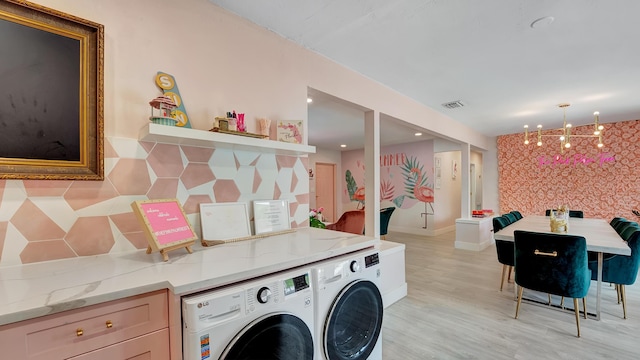 2600 NE 30th St, Fort Lauderdale, FL 33306 - laundry room featuring recessed lighting, separate washer and dryer, light wood-type flooring, and an inviting chandelier