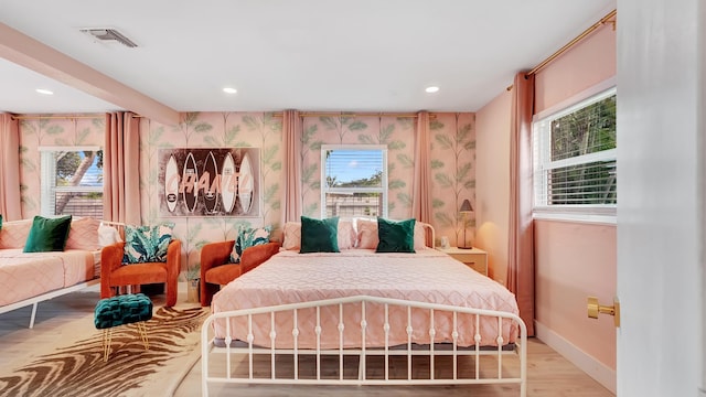 2600 NE 30th St, Fort Lauderdale, FL 33306 - bedroom with light wood-type flooring, baseboards, multiple windows, and visible vents