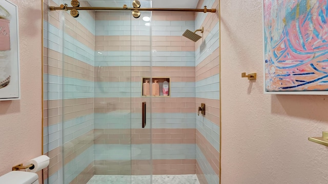 2600 NE 30th St, Fort Lauderdale, FL 33306 - full bath featuring a textured wall, a shower stall, and toilet