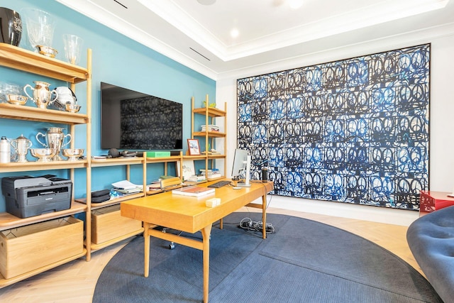 office space with ornamental molding, a tray ceiling, and parquet floors