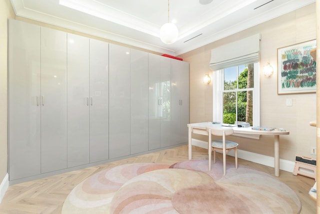 office space with a raised ceiling, ornamental molding, and light parquet floors