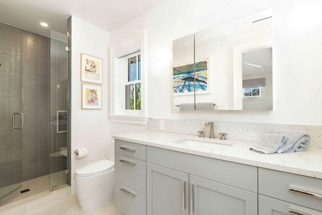 bathroom featuring walk in shower, vanity, and toilet