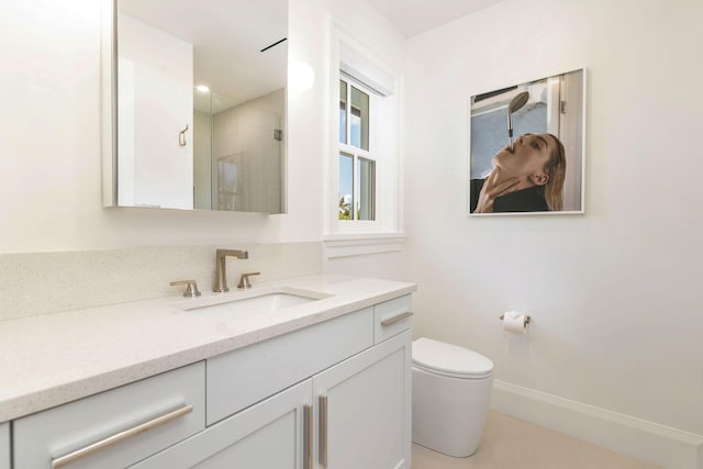 bathroom with walk in shower, vanity, and toilet