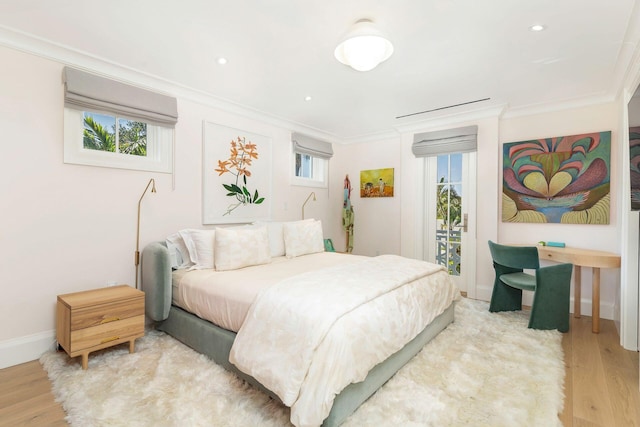 bedroom featuring light hardwood / wood-style flooring and multiple windows