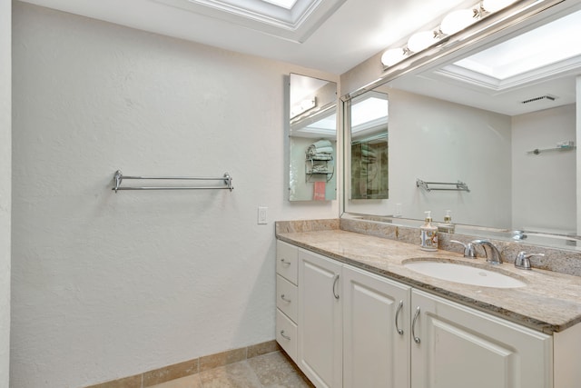 bathroom with vanity, crown molding, and a tray ceiling