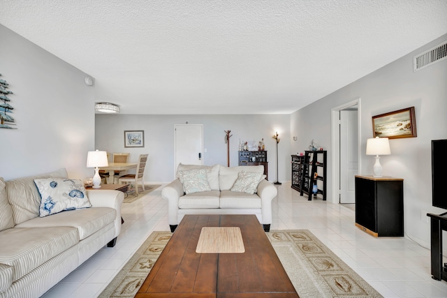 tiled living room with a textured ceiling