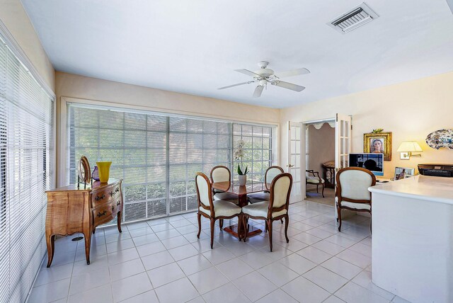 tiled dining room featuring ceiling fan