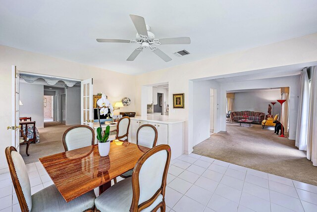 dining room featuring ceiling fan and light colored carpet