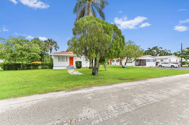 view of front of home featuring entry steps, an attached garage, driveway, and a front lawn