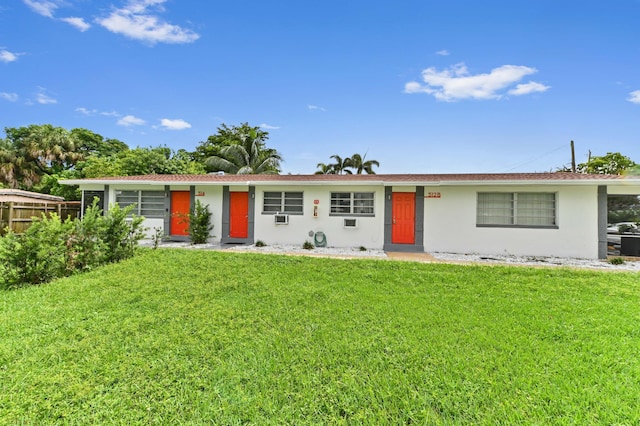 single story home featuring a front yard, cooling unit, and stucco siding