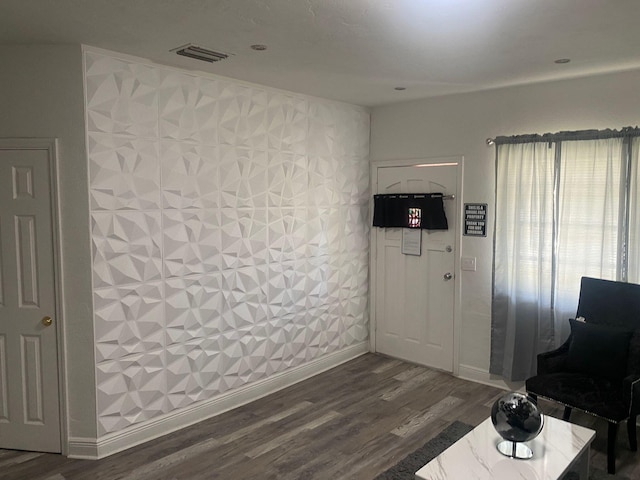 interior space featuring dark wood-style flooring, visible vents, and baseboards