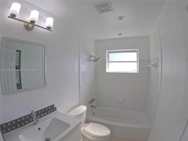 full bath with toilet, visible vents, tub / shower combination, and a sink