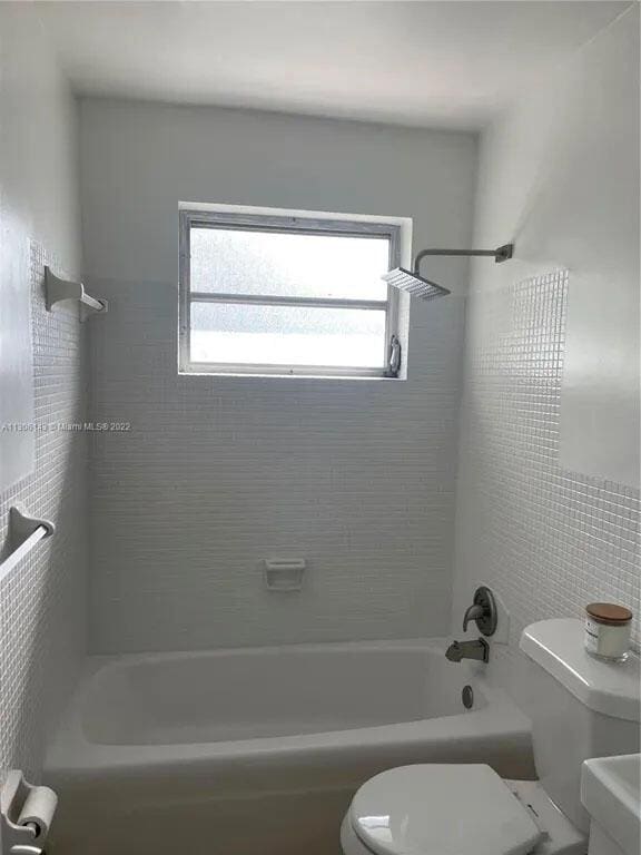 bathroom with shower / bath combination and toilet