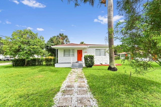 view of front of home with stucco siding and a front yard