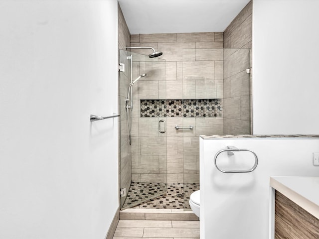 bathroom featuring walk in shower, vanity, and toilet