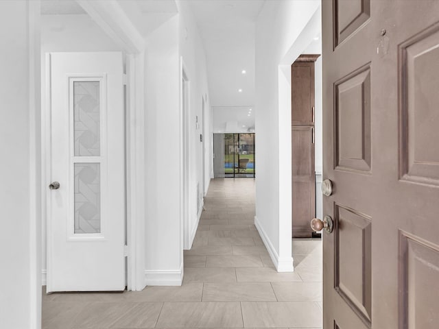 corridor featuring light tile patterned flooring