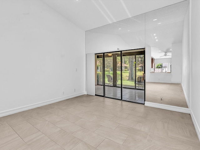 unfurnished room with ceiling fan and lofted ceiling