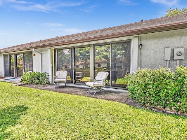 rear view of property with a yard