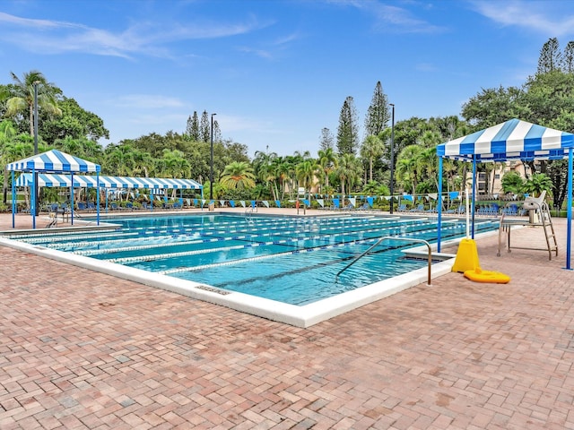 view of swimming pool with a playground