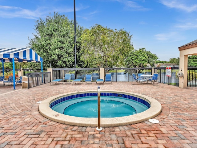 view of pool featuring a patio, a community hot tub, and a pergola