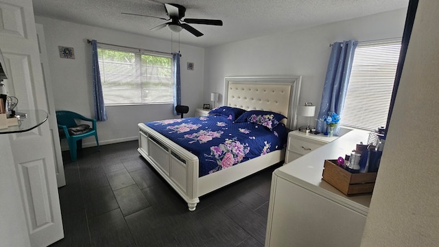 bedroom with ceiling fan and a textured ceiling