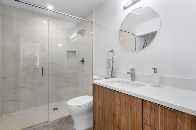 bathroom with toilet, a shower with door, and vanity