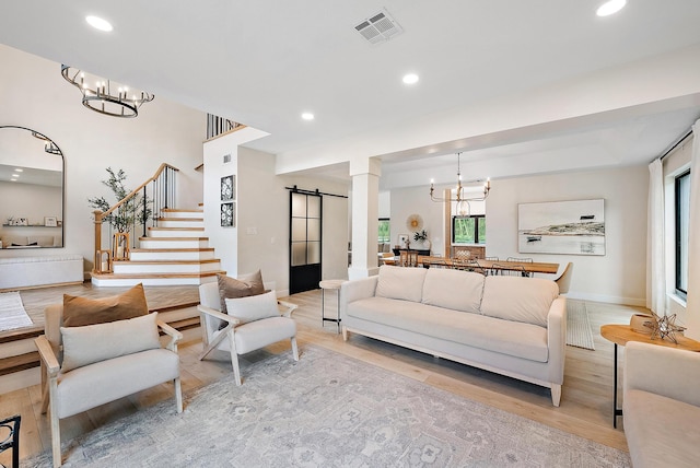 living room with light hardwood / wood-style flooring and a barn door