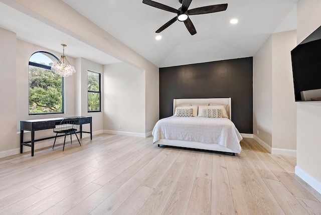 bedroom featuring light hardwood / wood-style floors, lofted ceiling, and ceiling fan with notable chandelier