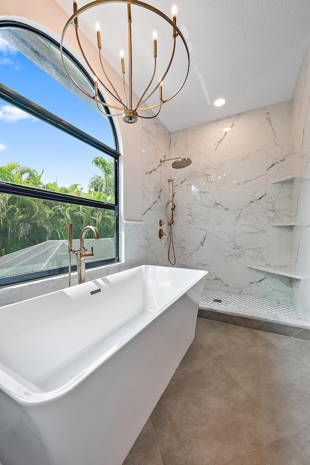 bathroom featuring concrete floors, a notable chandelier, a textured ceiling, and plus walk in shower