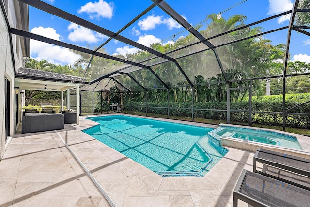 view of pool featuring ceiling fan, glass enclosure, a patio, an outdoor living space, and an in ground hot tub