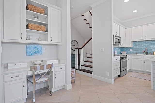 kitchen featuring backsplash, white cabinetry, stainless steel appliances, and light countertops