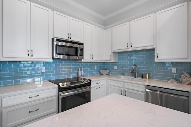 kitchen featuring appliances with stainless steel finishes, decorative backsplash, white cabinetry, and sink