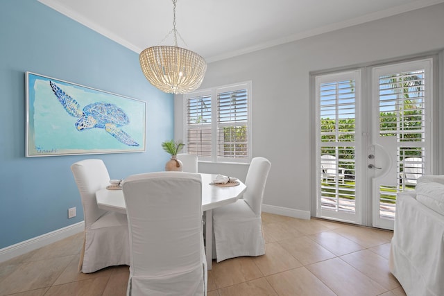 tiled dining space with baseboards, ornamental molding, and a chandelier